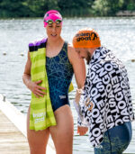 Lifestyle image of man holding legacy towel and woman holding lithium towel beside a lake