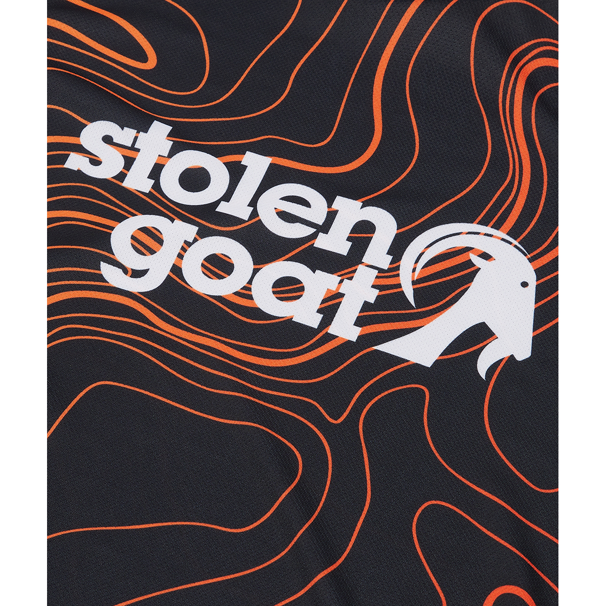 Close up of logo on Stolen Goat women's Topo mountain bike jersey black long-sleeved jersey with orange topographical design