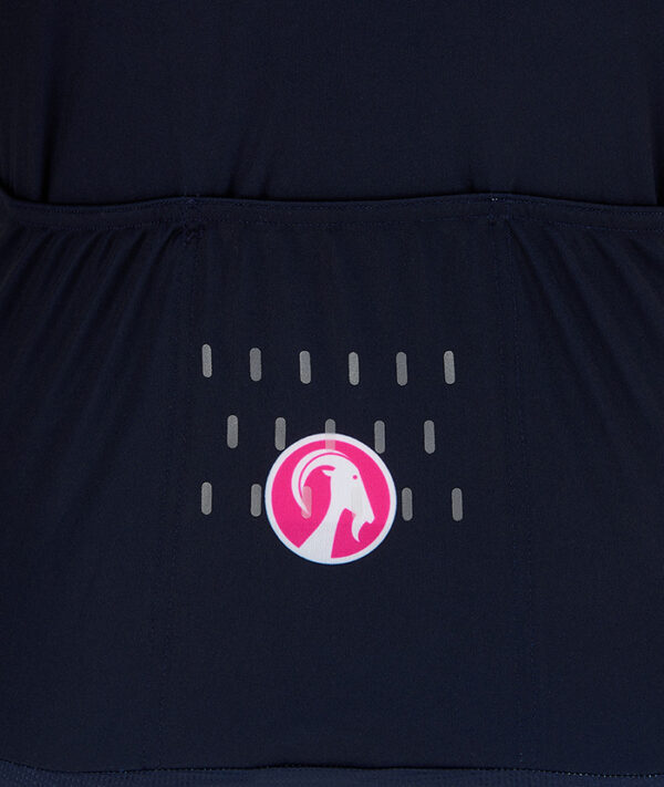 Close up of the rear goat head circle logo and reflective details on the back pocket of women's Blast jersey