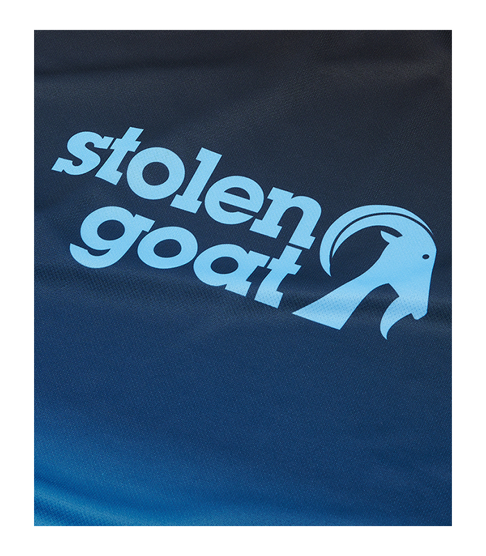 Close up of front logo on Stolen Goat Zion mountain bike jersey with blue gradient fade design